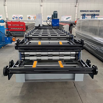 Compact double layer roll forming machine producing two trapezoidal roof sheet profiles efficiently.