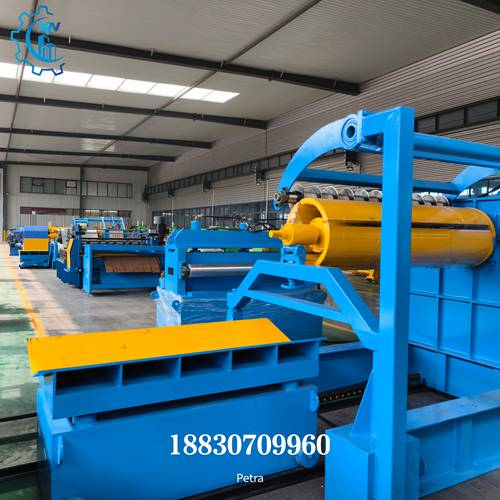 Close-up of steel slitting line recoiler with take-up car, damping device, and slitting station components